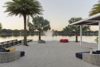 a dock with palm trees and a fountain  and a lake at Lakeside Villas, Orlando, 32817